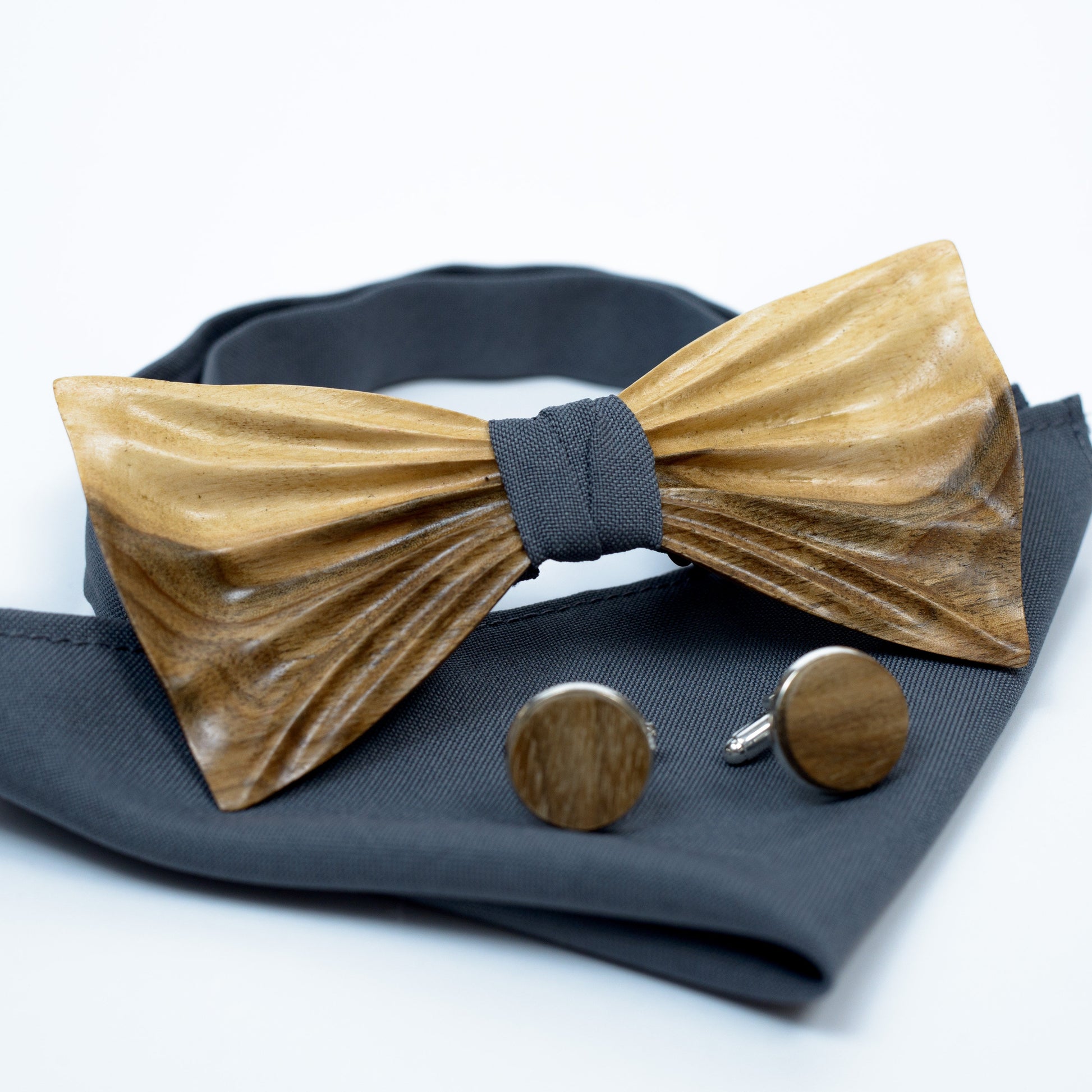 Handmade walnut wooden bow tie set with personalized cufflinks and matching pocket square, displayed in a wooden gift box.