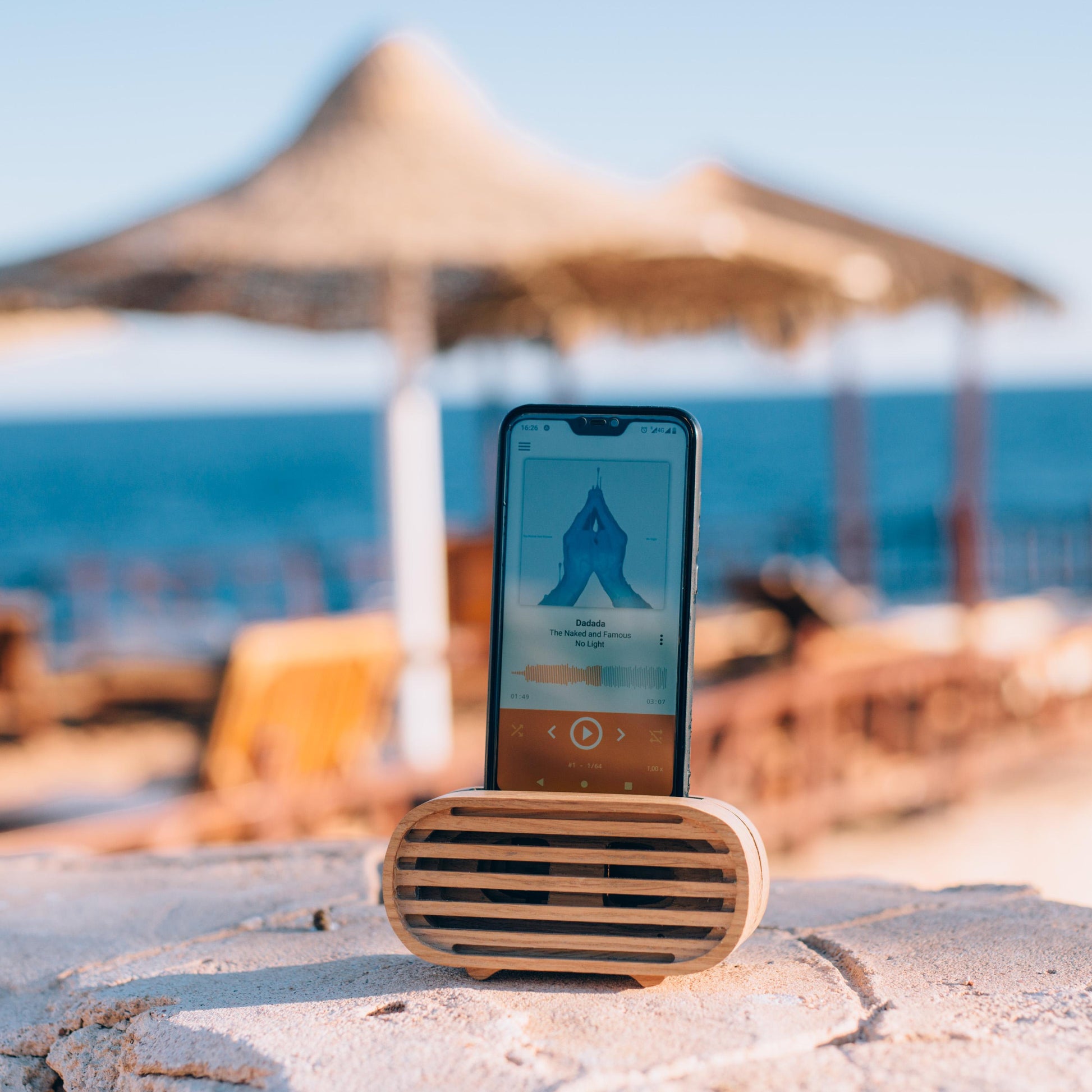 Rustic wooden phone speaker in home office, eco-friendly sound amplifier for music lovers