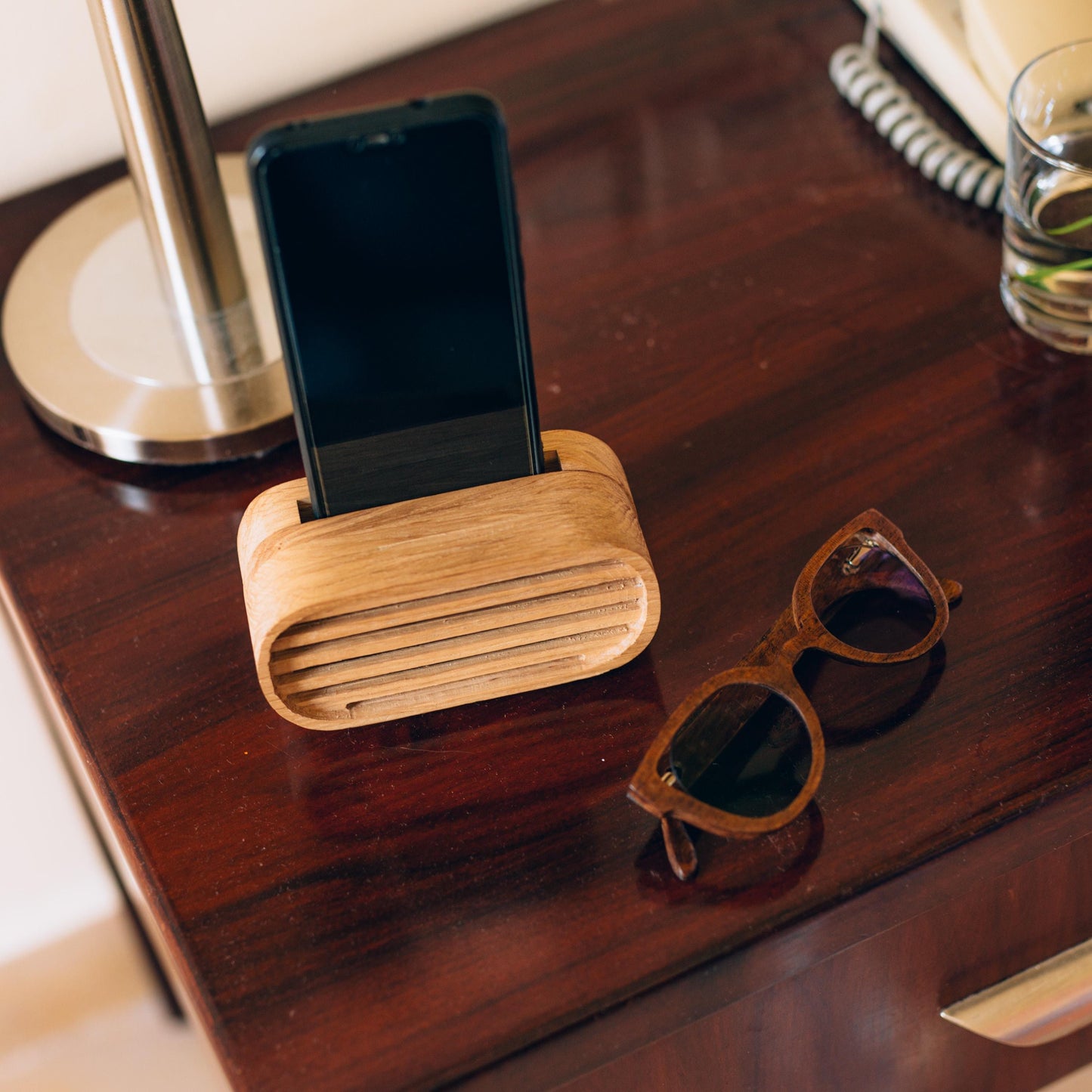Oak wood phone stand with passive amplifier, boosts sound naturally, fits iPhone and Android.