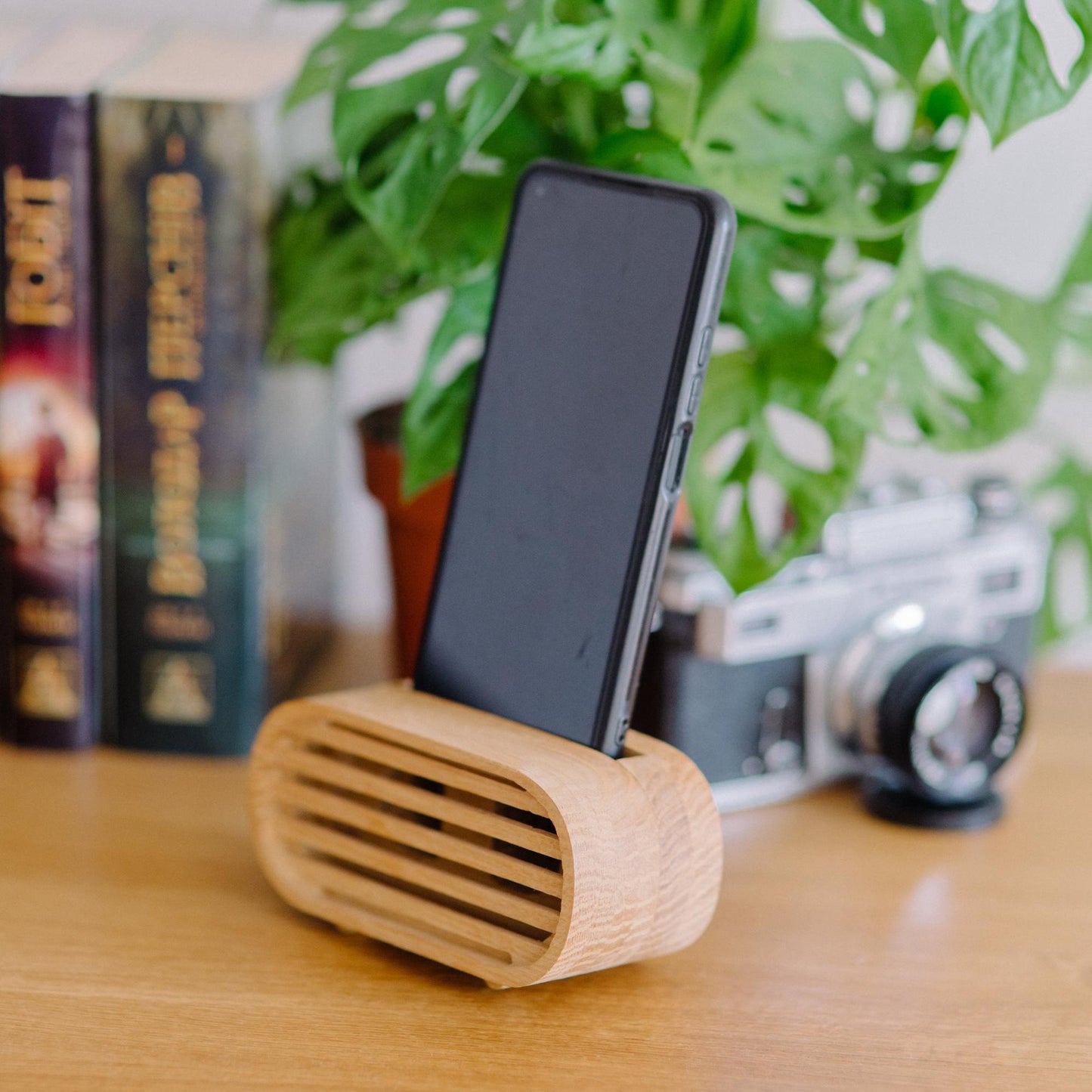 Rustic wooden phone speaker in home office, eco-friendly sound amplifier for music lovers