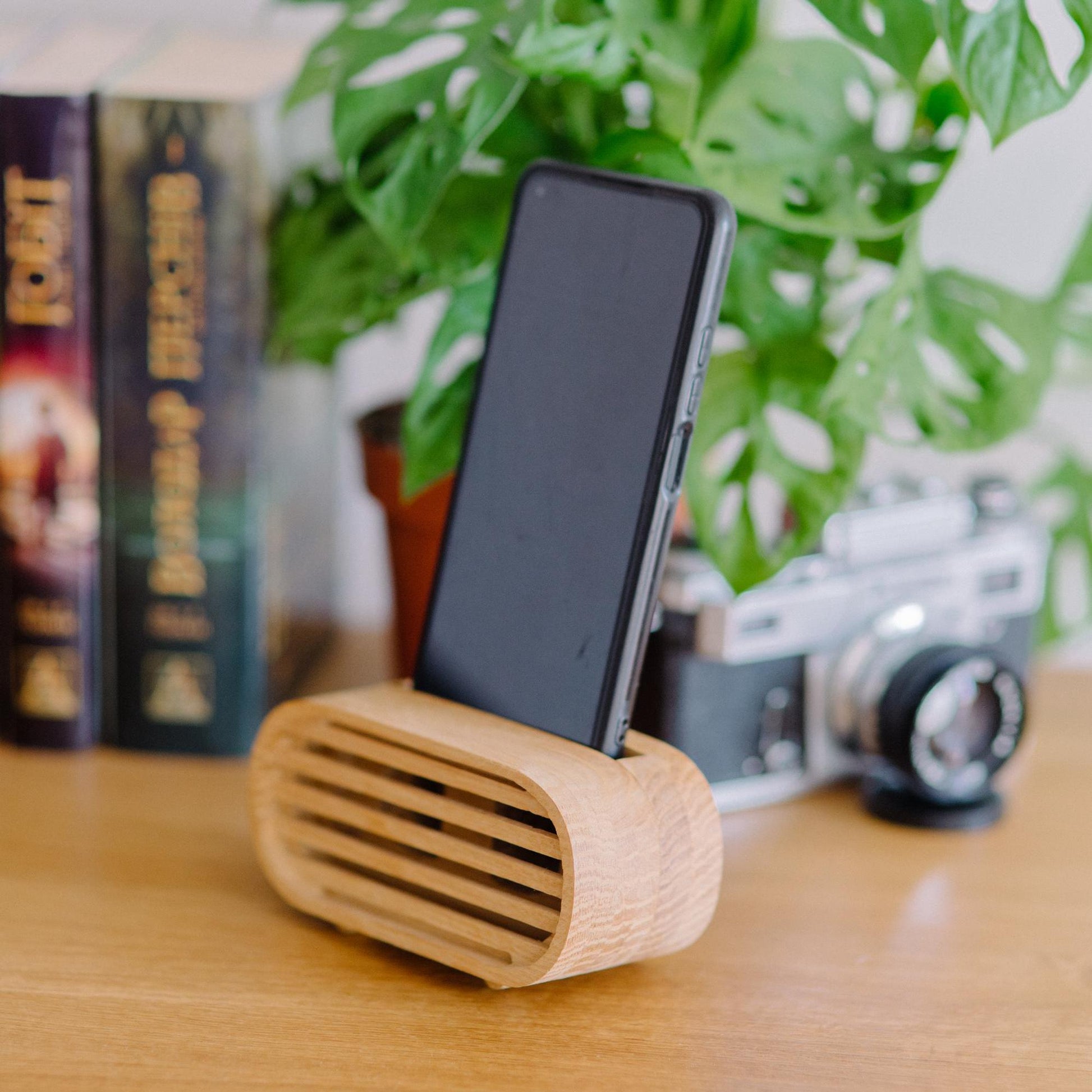 Rustic wooden phone speaker in home office, eco-friendly sound amplifier for music lovers