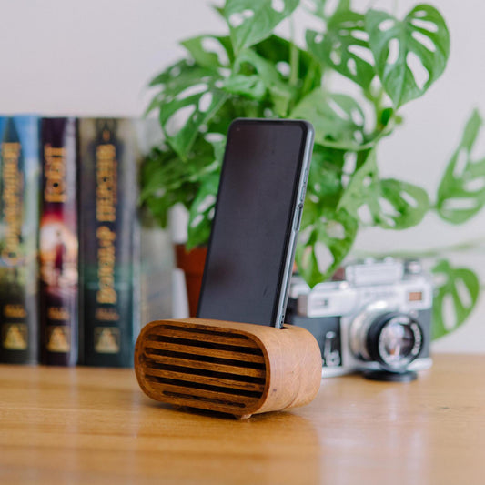 Rustic wooden phone speaker in home office, eco-friendly sound amplifier for music lovers