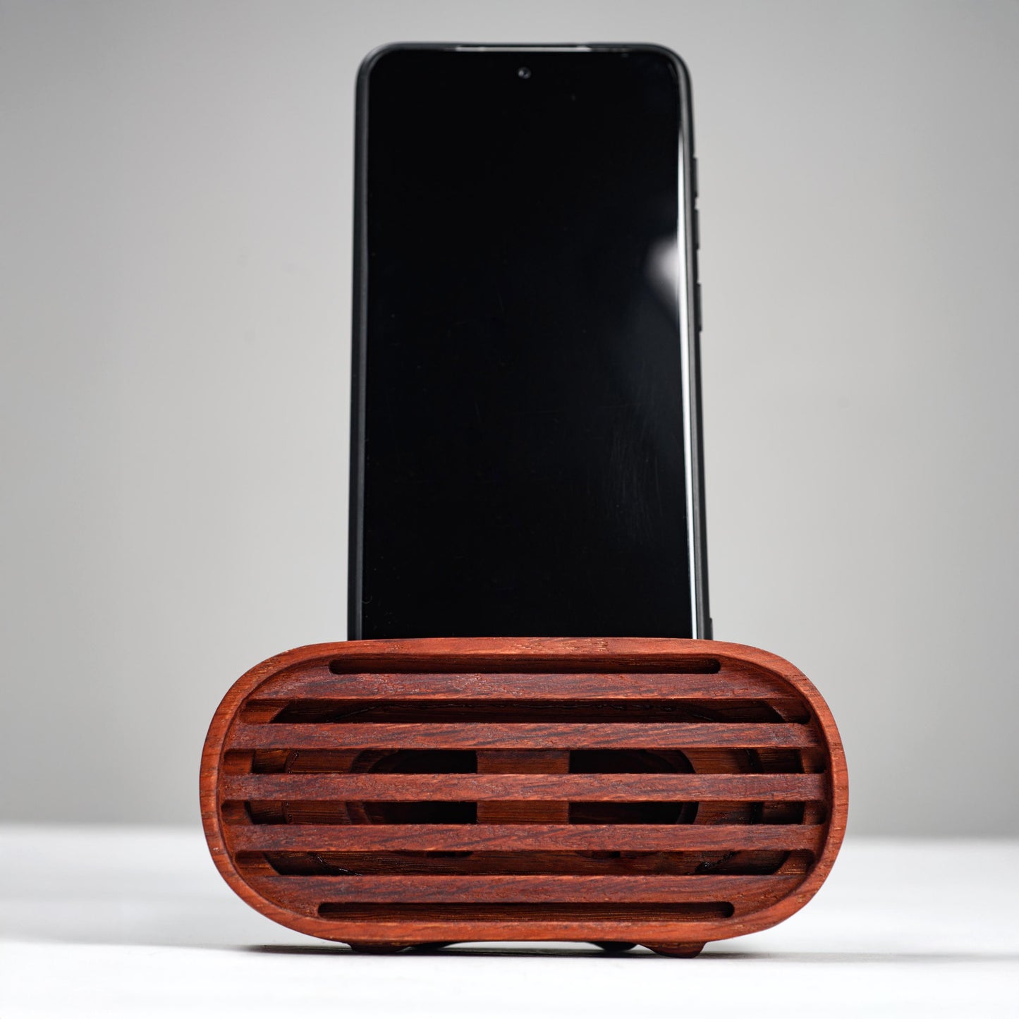 Oak wood phone stand with passive amplifier, boosts sound naturally, fits iPhone and Android.