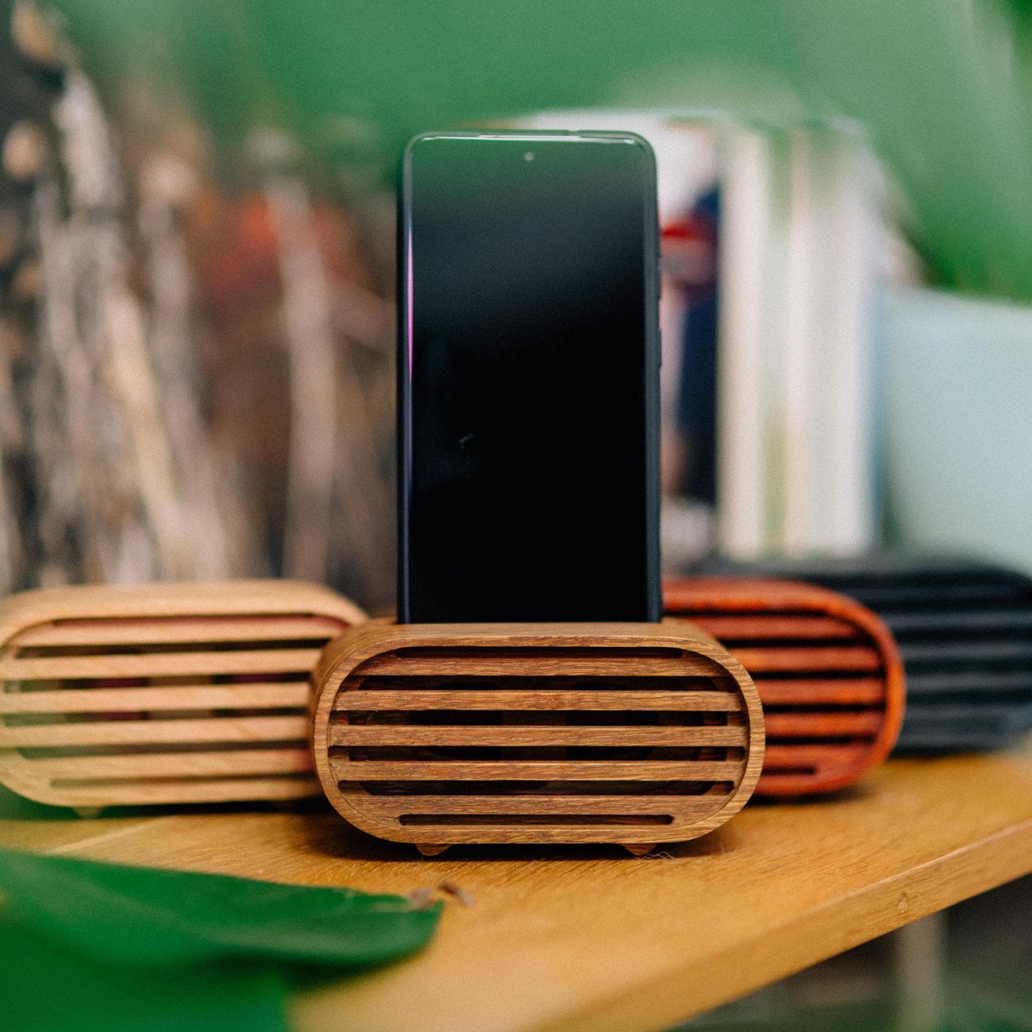 Rustic wooden phone speaker in home office, eco-friendly sound amplifier for music lovers.