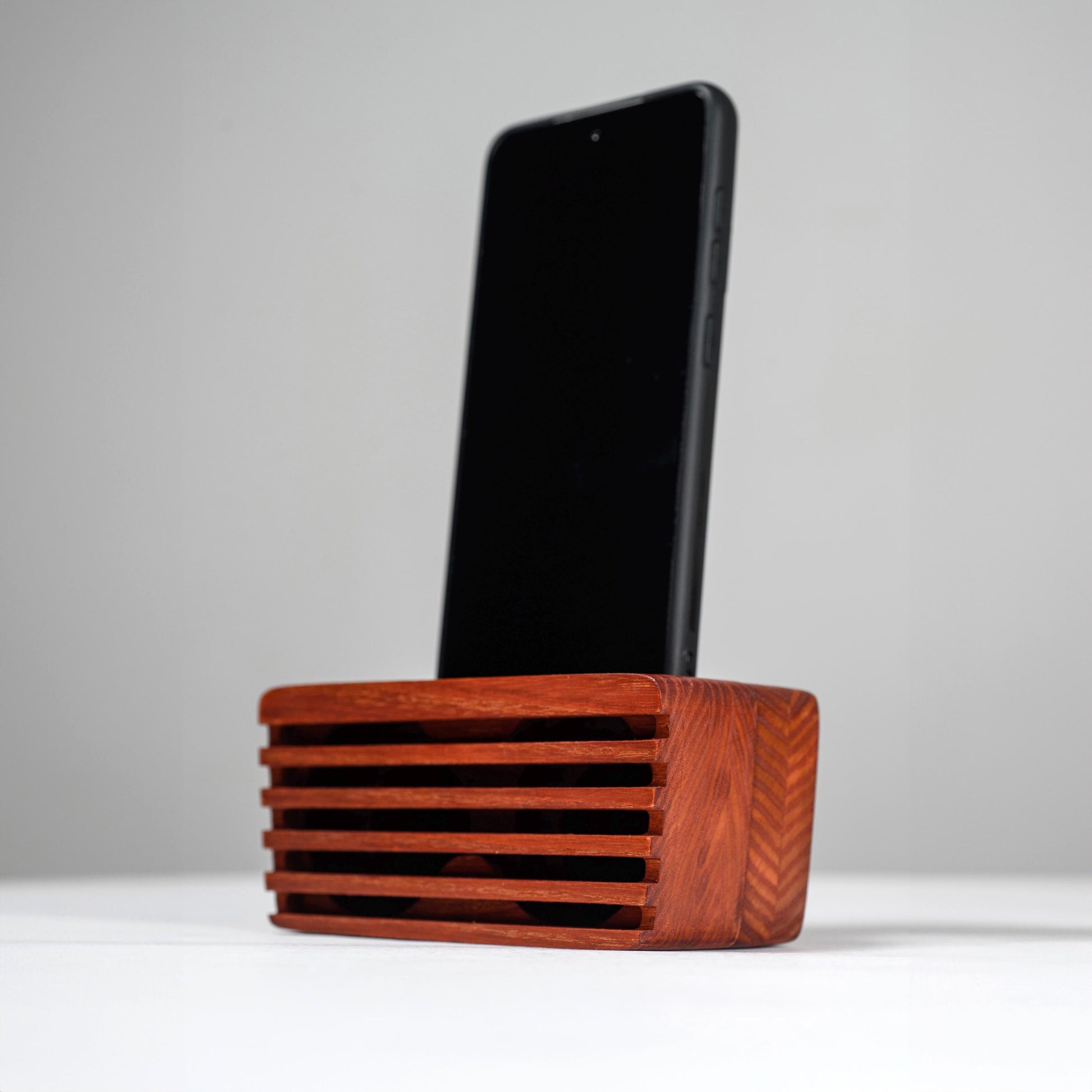Ash wood phone stand with passive amplifier, doubles as a charging station and desk organizer.