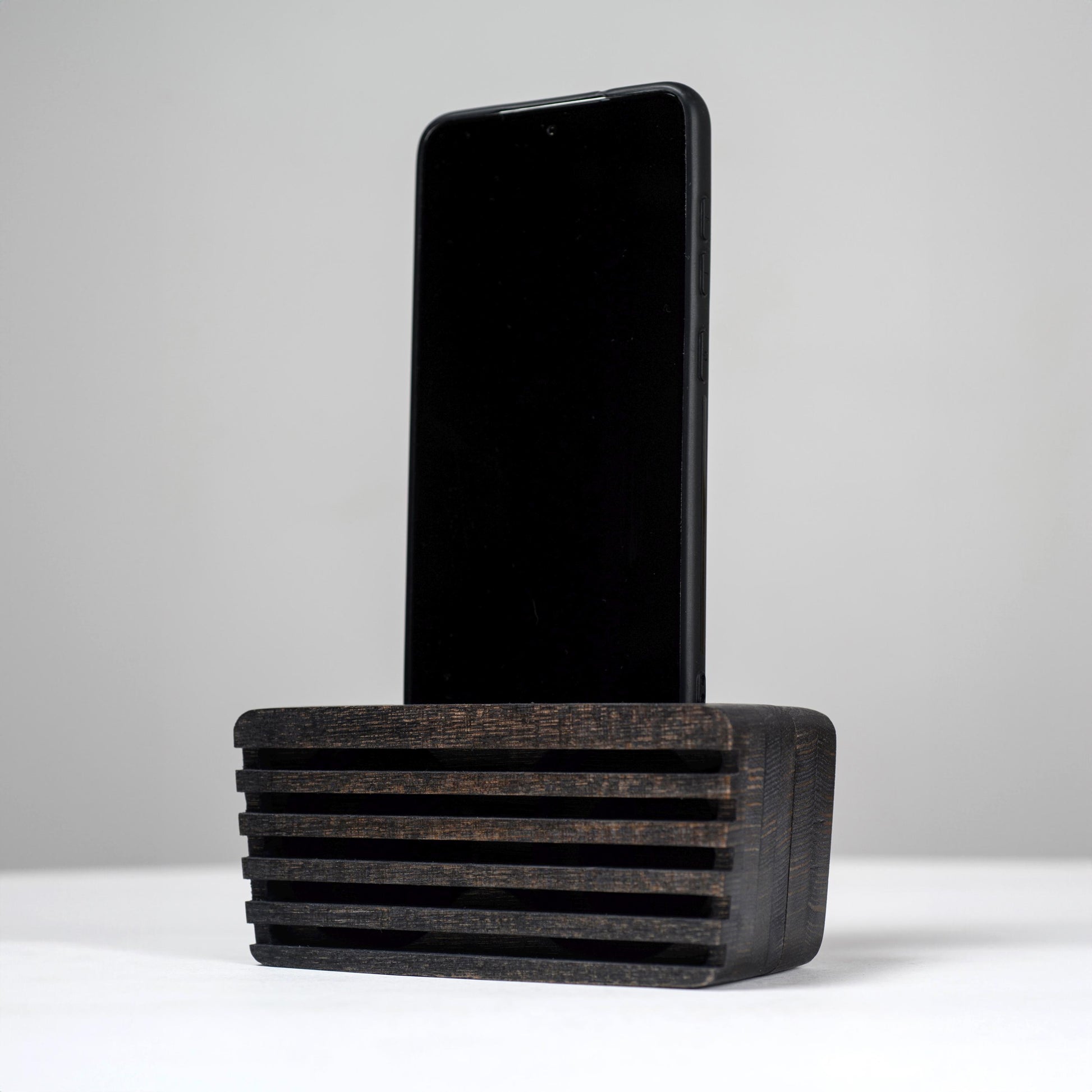 Ash wood phone stand with passive amplifier, doubles as a charging station and desk organizer.