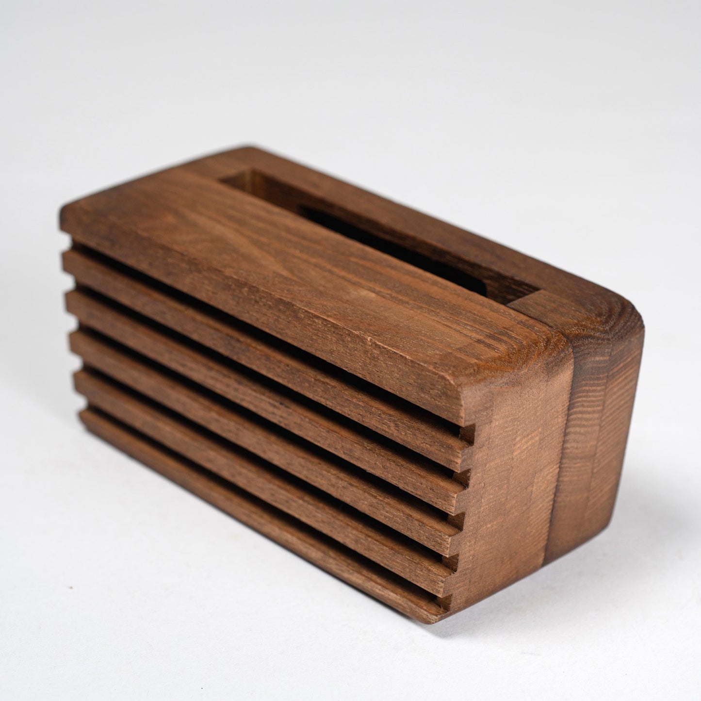 Compact wooden sound amplifier for smartphones, handcrafted and eco-friendly design.
