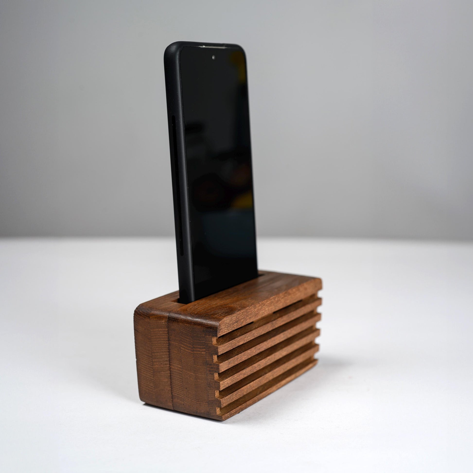 Ash wood phone stand with passive amplifier, doubles as a charging station and desk organizer.