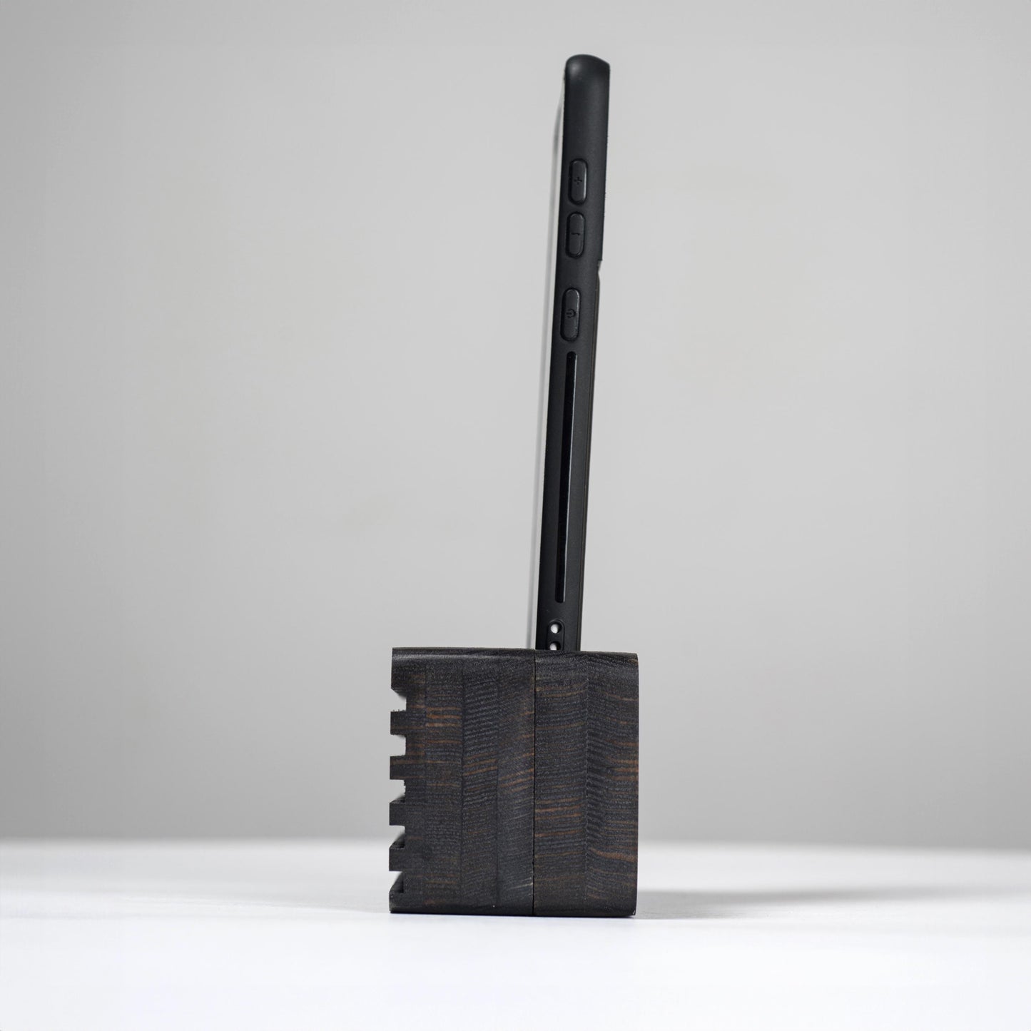 Ash wood phone stand with passive amplifier, doubles as a charging station and desk organizer.