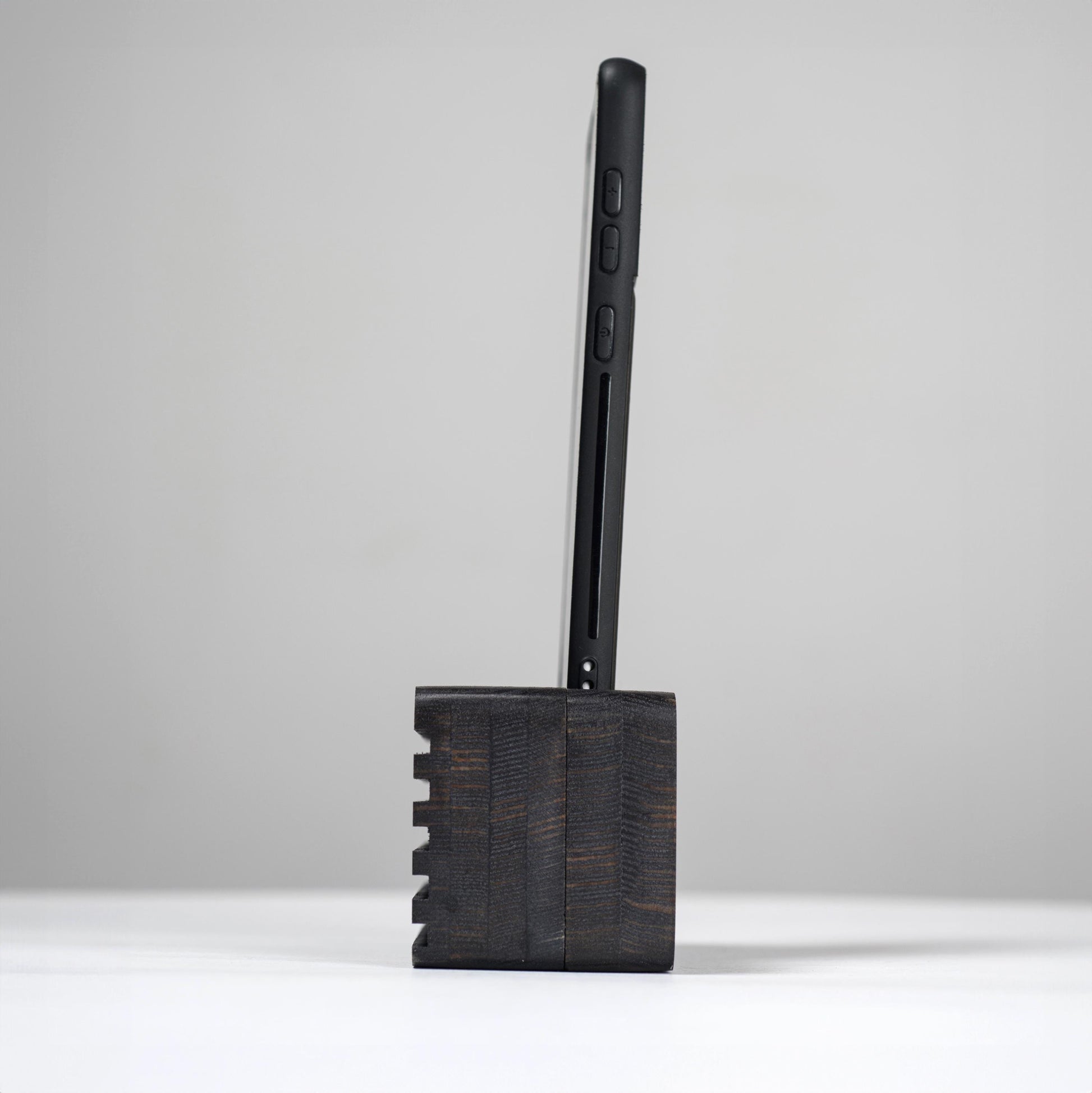 Ash wood phone stand with passive amplifier, doubles as a charging station and desk organizer.