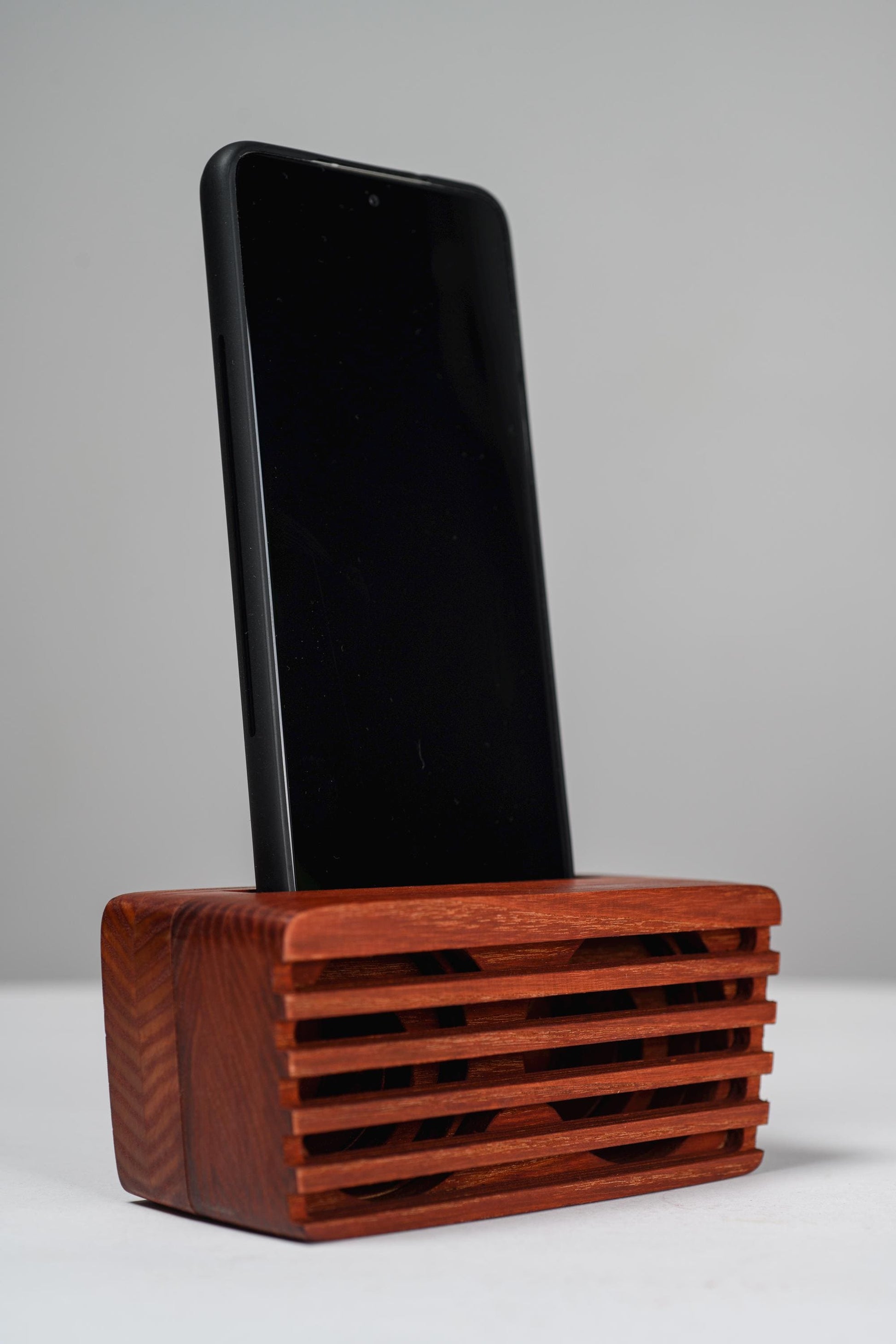 Ash wood phone stand with passive amplifier, doubles as a charging station and desk organizer.