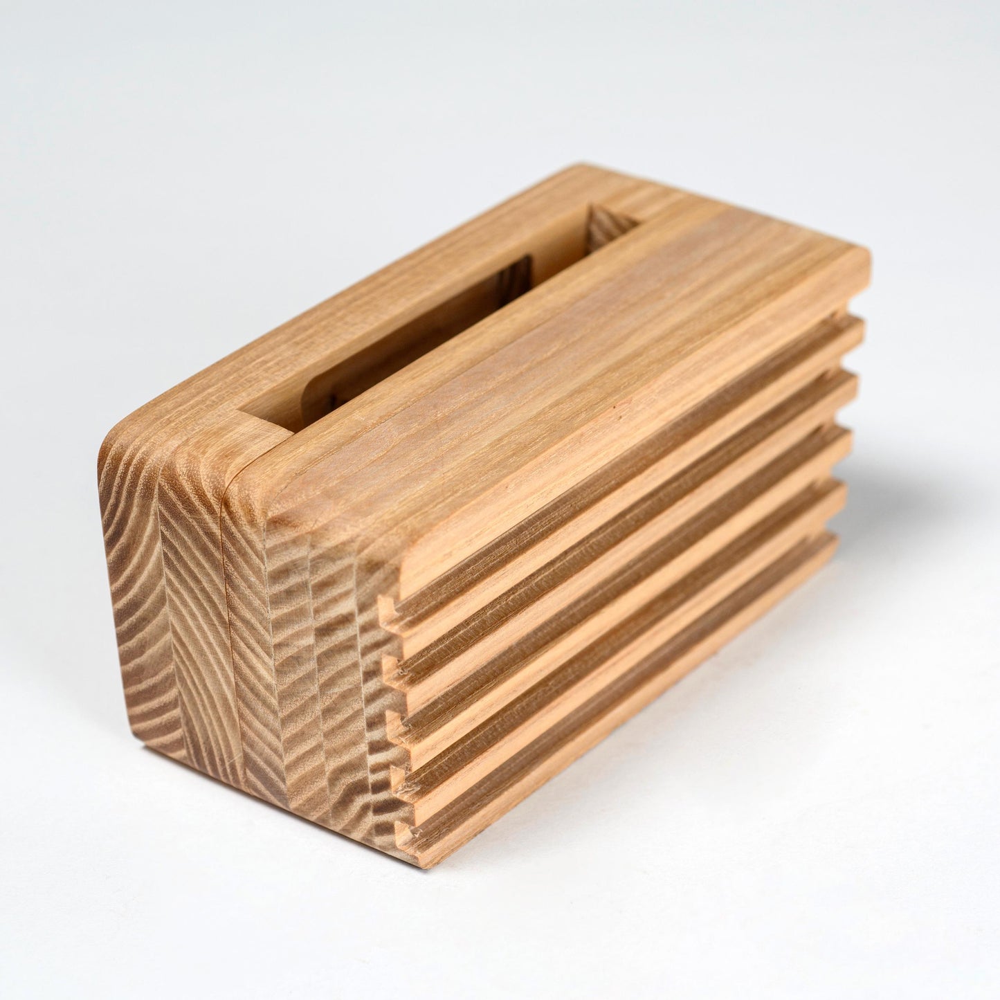 Compact wooden sound amplifier for smartphones, handcrafted and eco-friendly design.