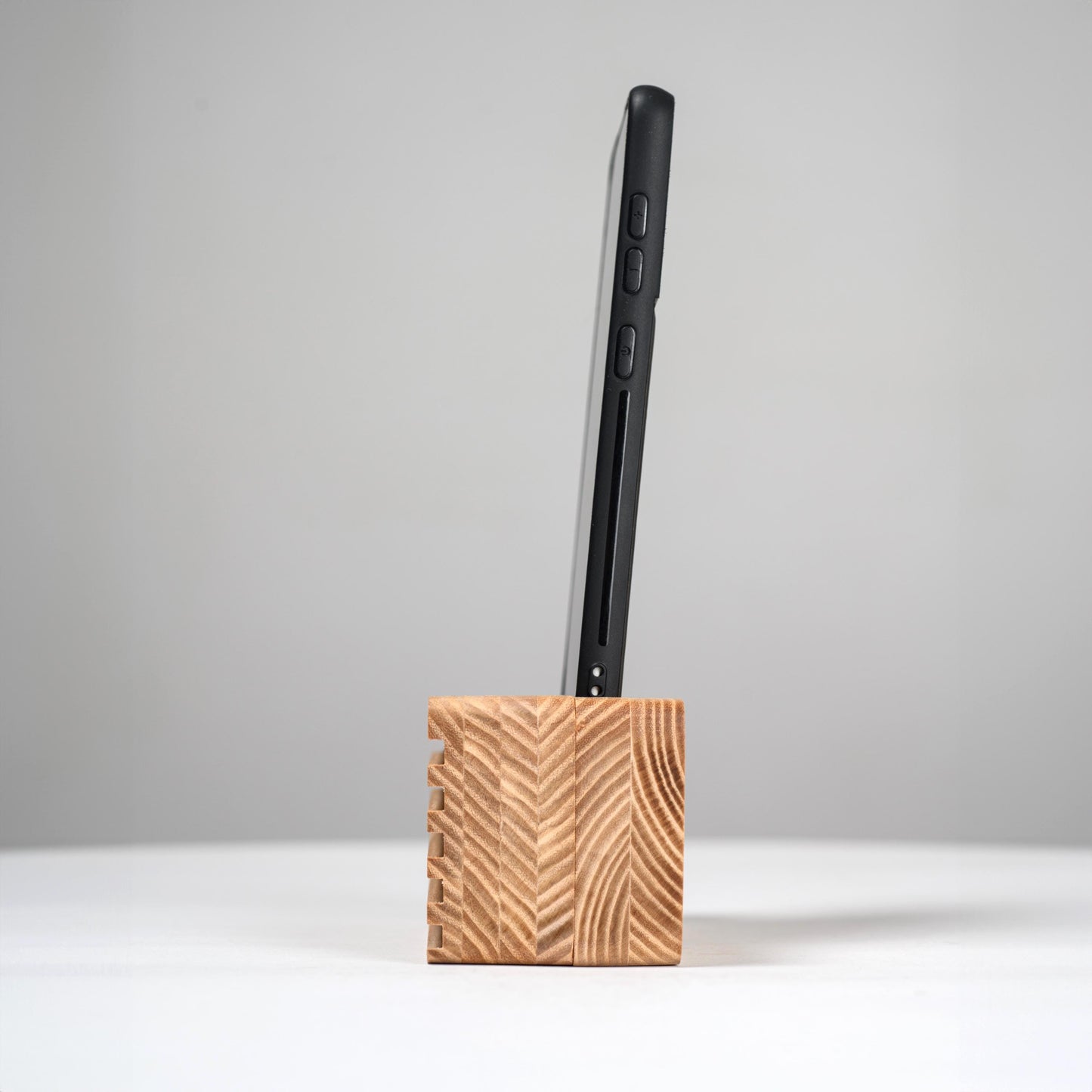 Ash wood phone stand with passive amplifier, doubles as a charging station and desk organizer.