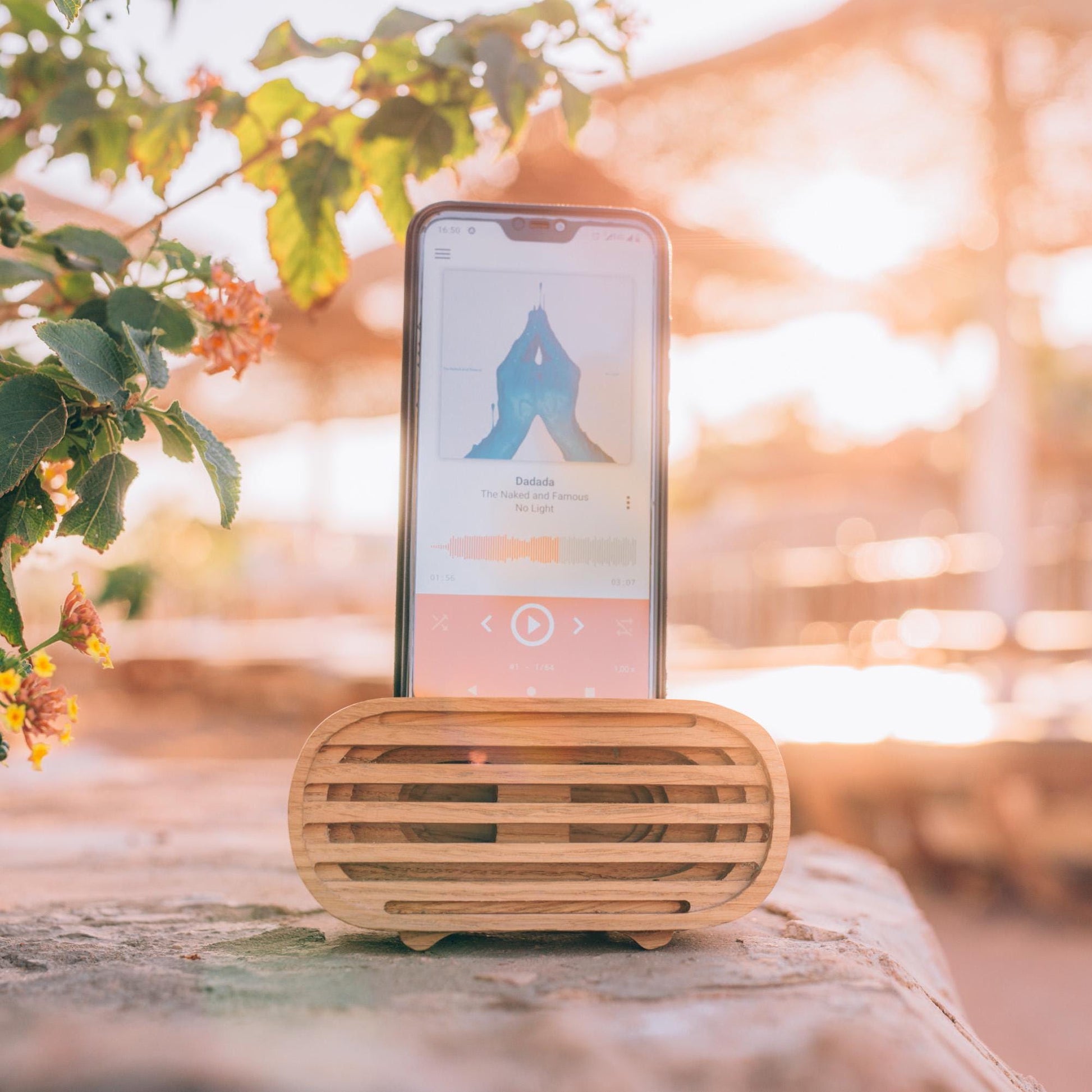 Oak wood phone stand with passive amplifier, boosts sound naturally, fits iPhone and Android.