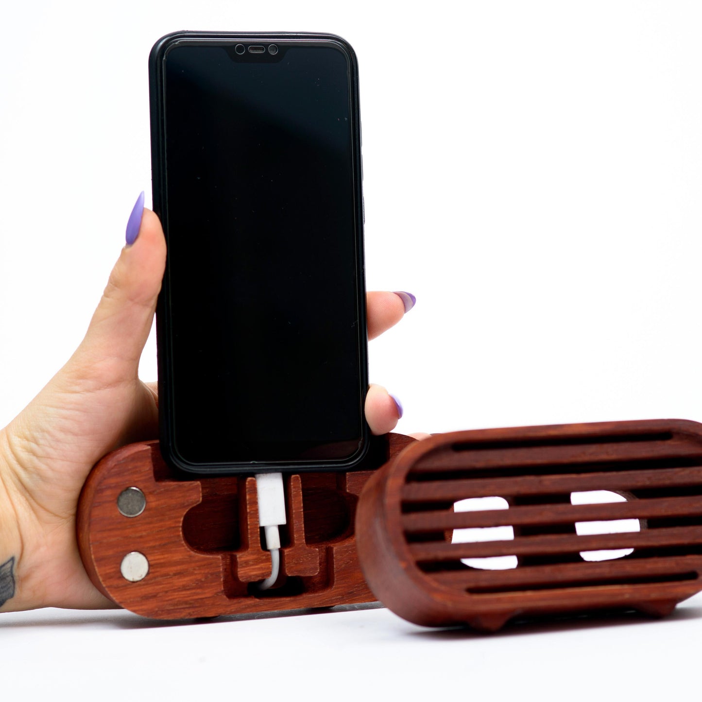 Rustic wooden phone speaker in home office, eco-friendly sound amplifier for music lovers.