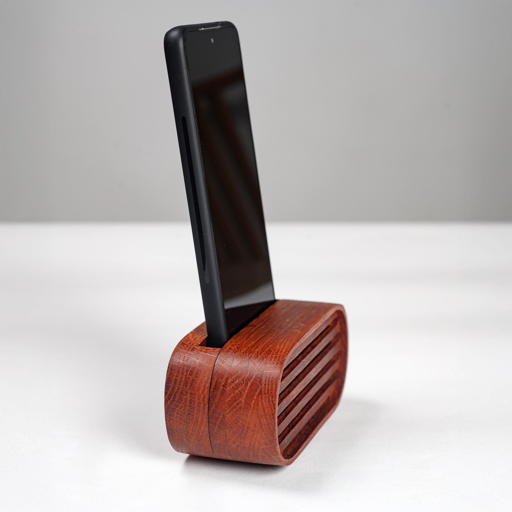 Oak wood phone stand with passive amplifier, boosts sound naturally, fits iPhone and Android.