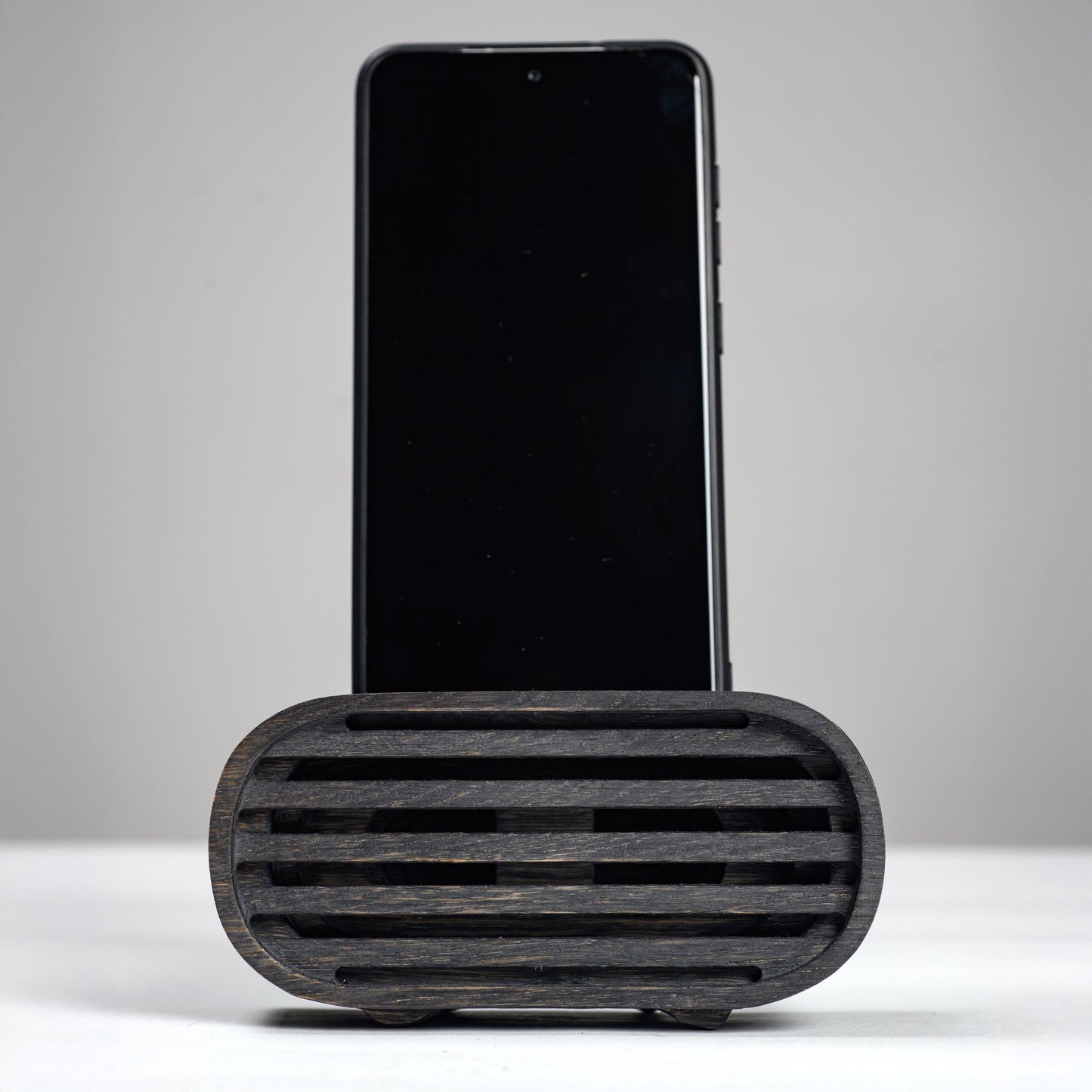 Oak wood phone stand with passive amplifier, boosts sound naturally, fits iPhone and Android.