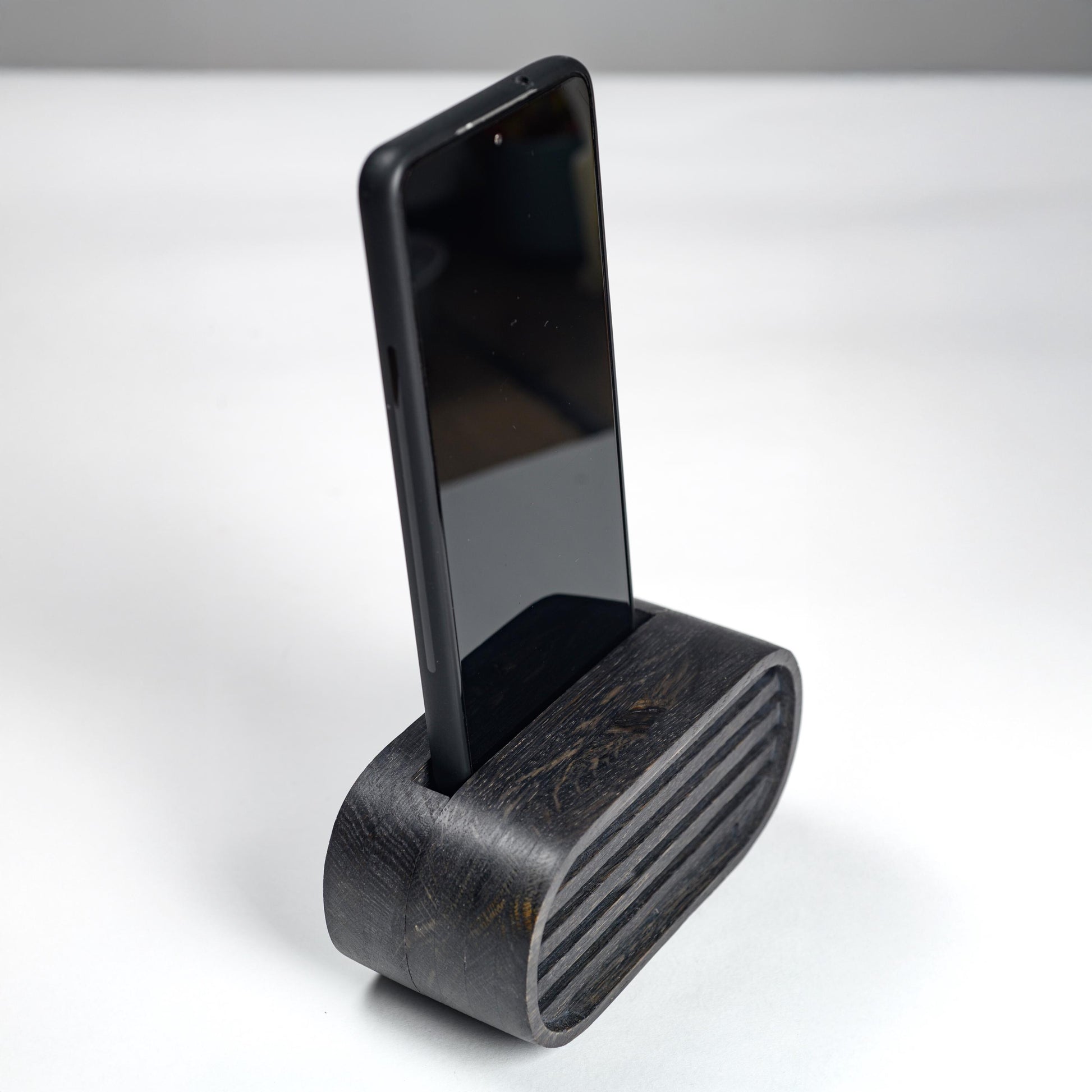 Oak wood phone stand with passive amplifier, boosts sound naturally, fits iPhone and Android.