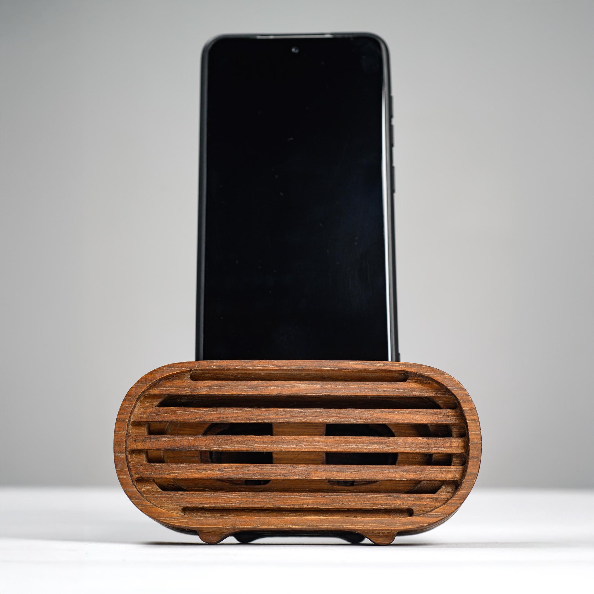 Oak wood phone stand with passive amplifier, boosts sound naturally, fits iPhone and Android.