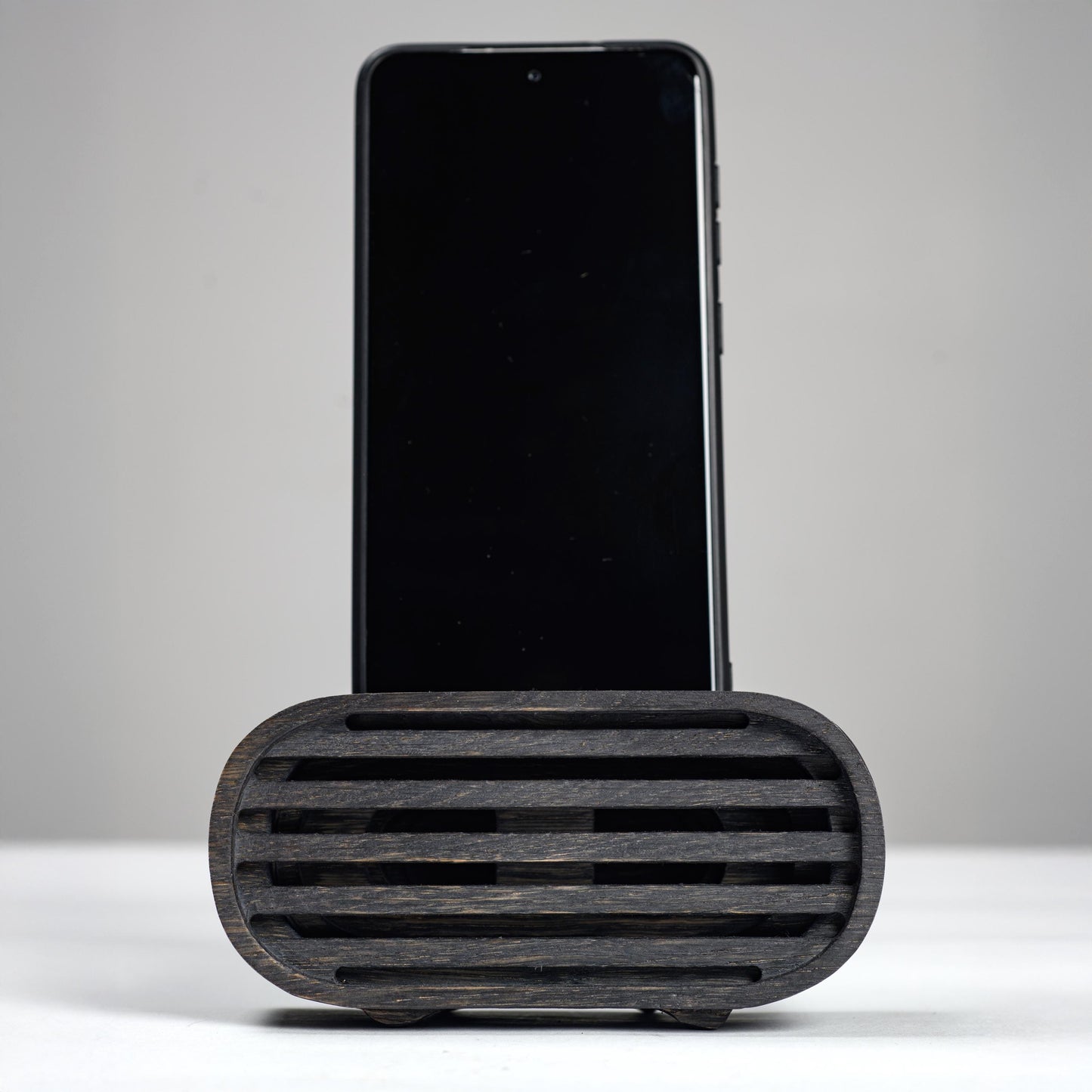 Oak wood phone stand with passive amplifier, boosts sound naturally, fits iPhone and Android.