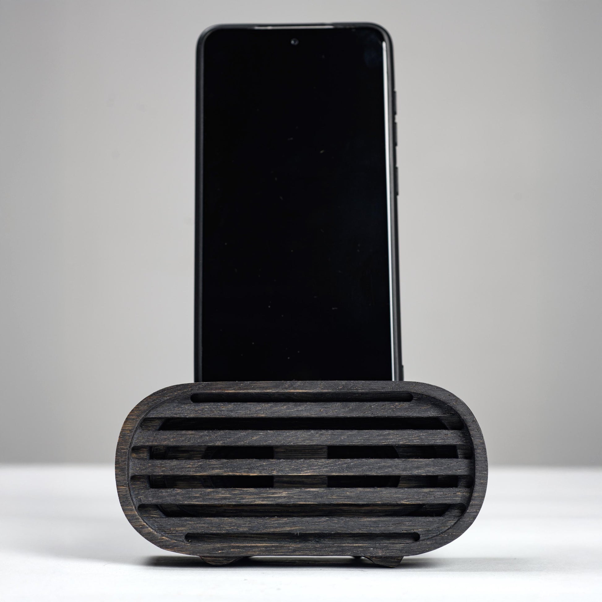 Oak wood phone stand with passive amplifier, boosts sound naturally, fits iPhone and Android.