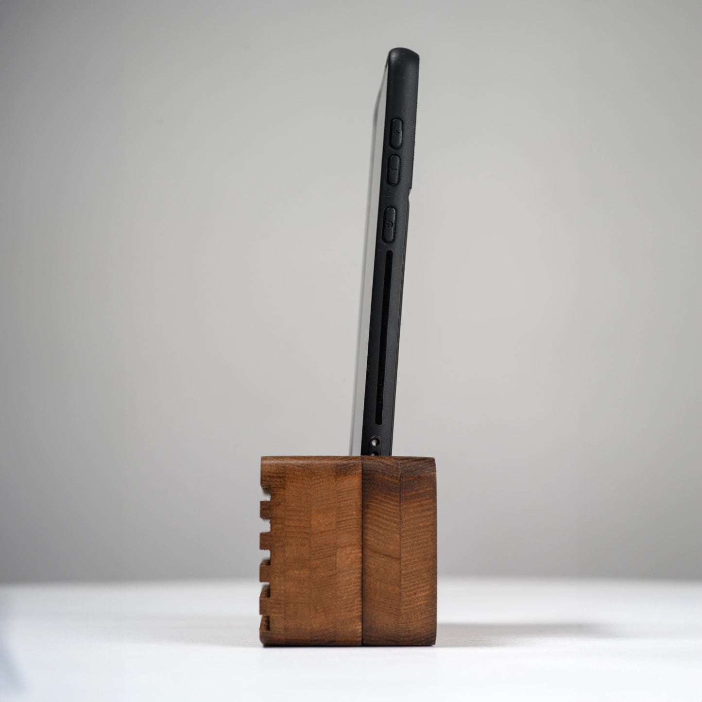 Ash wood phone stand with passive amplifier, doubles as a charging station and desk organizer.