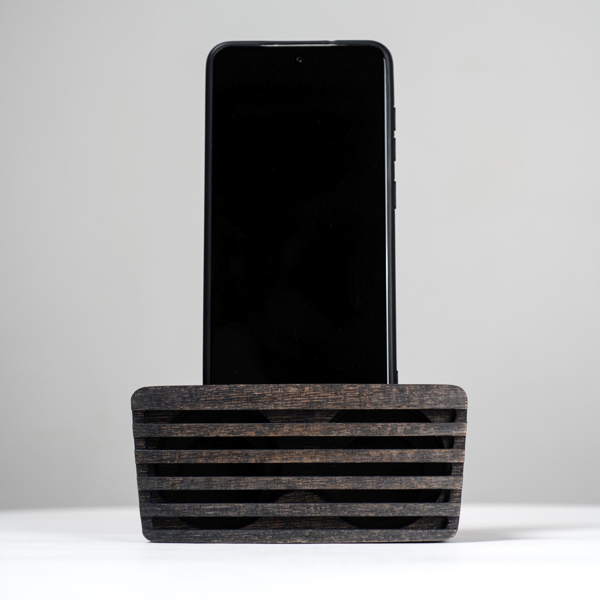 Ash wood phone stand with passive amplifier, doubles as a charging station and desk organizer.