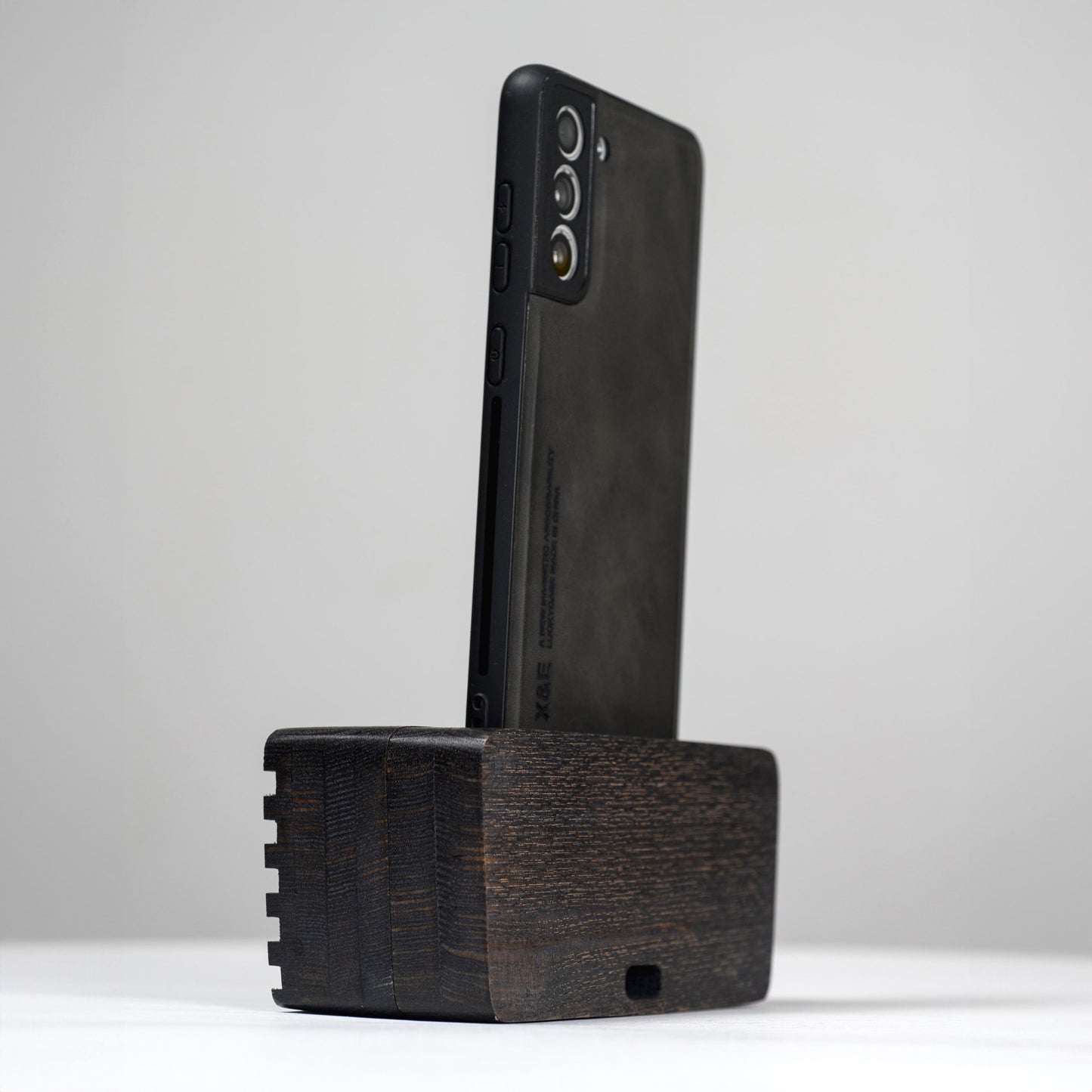Ash wood phone stand with passive amplifier, doubles as a charging station and desk organizer.