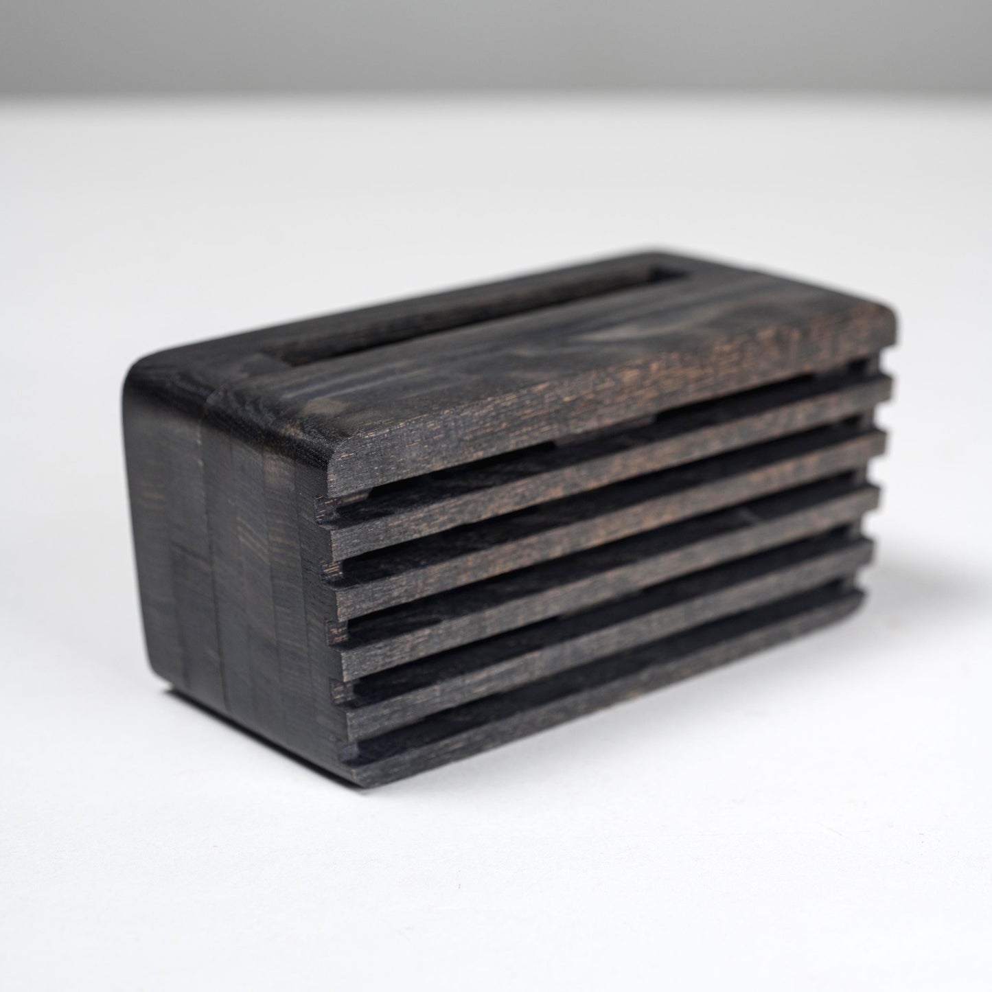 Compact wooden sound amplifier for smartphones, handcrafted and eco-friendly design.