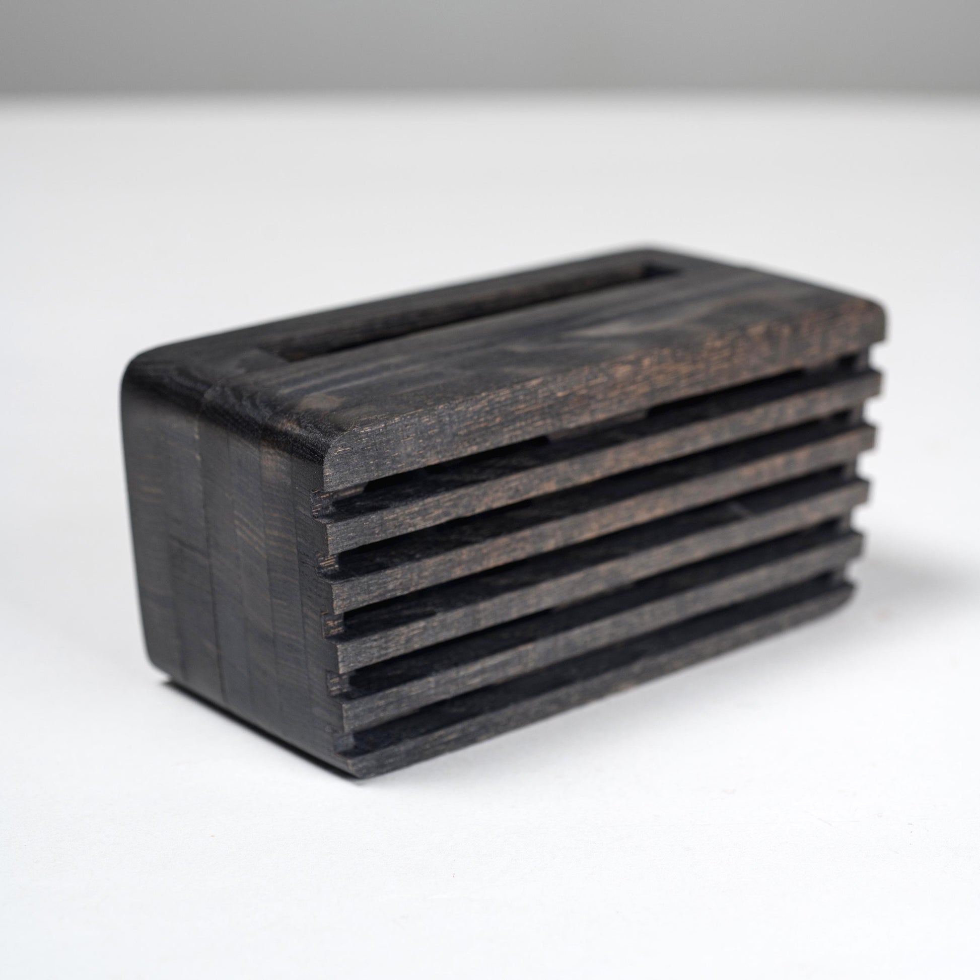Compact wooden sound amplifier for smartphones, handcrafted and eco-friendly design.