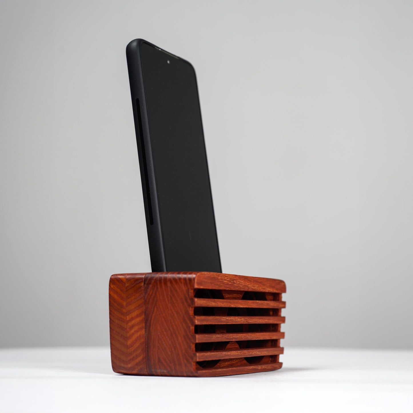 Ash wood phone stand with passive amplifier, doubles as a charging station and desk organizer.