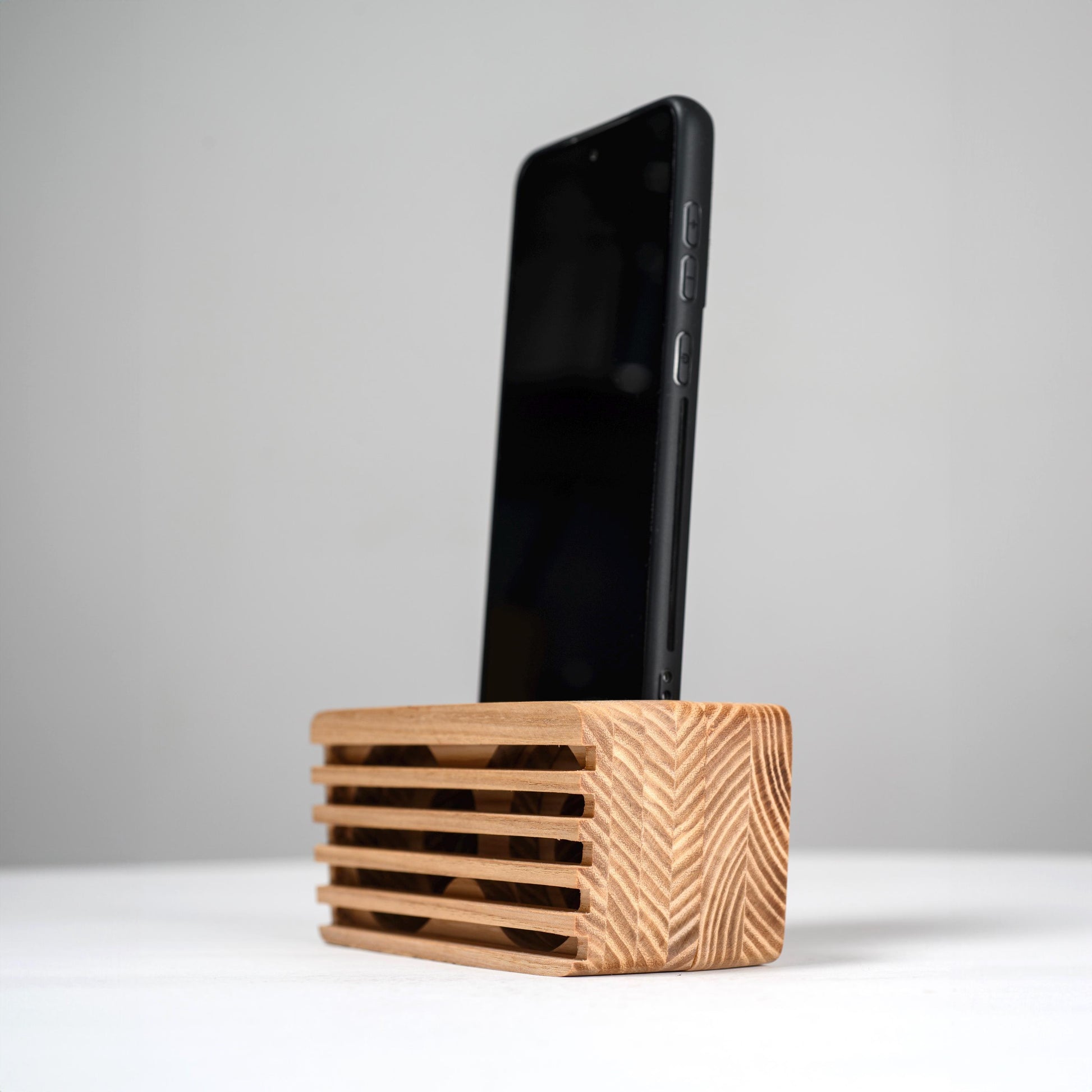 Ash wood phone stand with passive amplifier, doubles as a charging station and desk organizer.