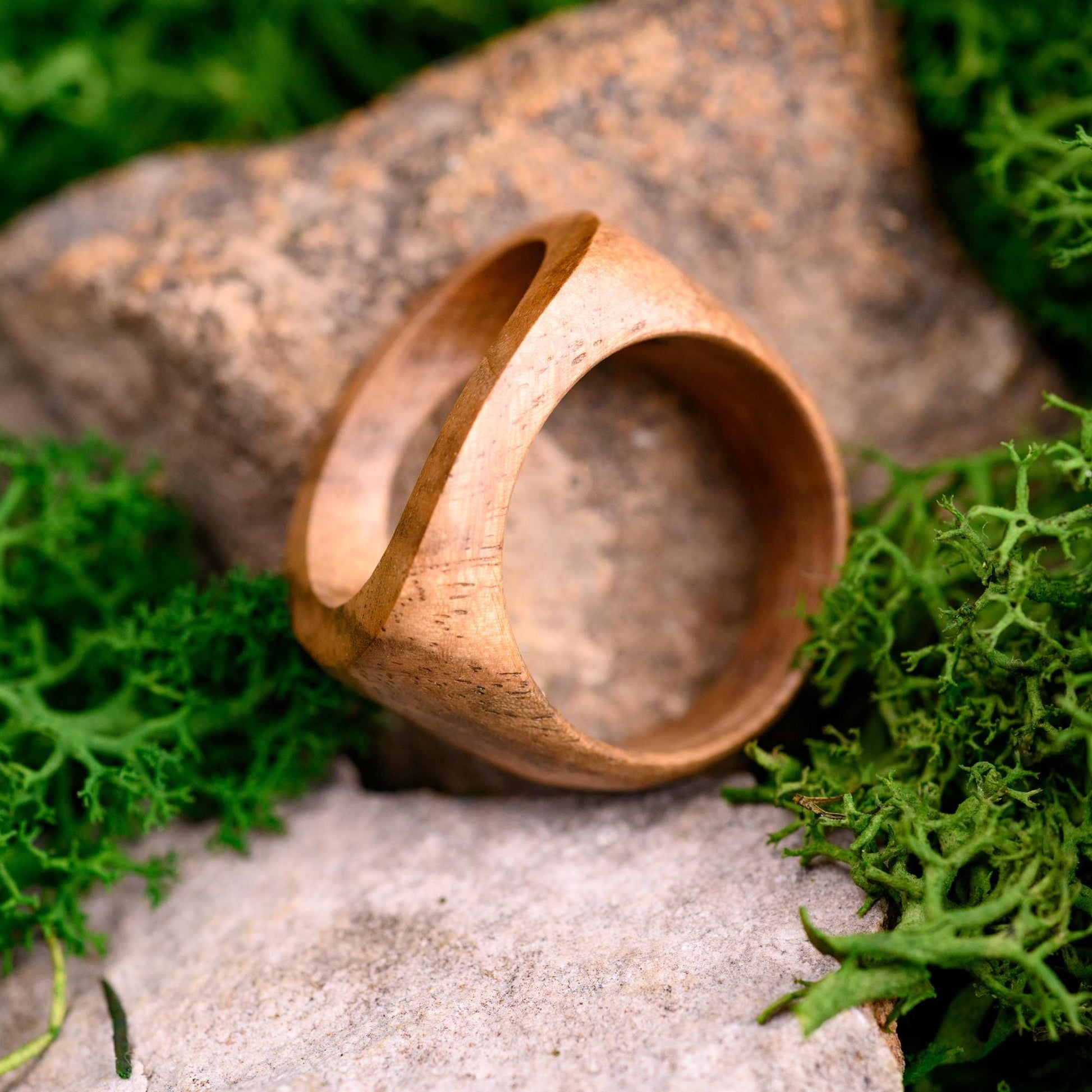 Minimalist men's wood ring with a sleek, organic look, perfect as an anniversary ring.