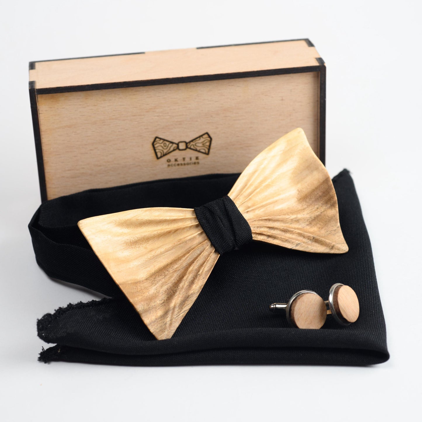 Handmade walnut wooden bow tie set with personalized cufflinks and matching pocket square, displayed in a wooden gift box.