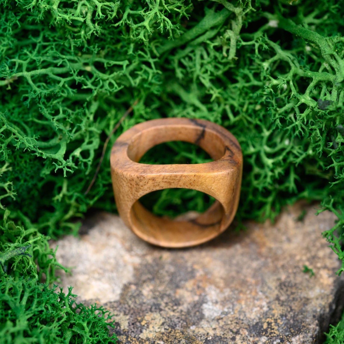 Close-up of a promise ring made from natural wood, a perfect gift for husband.