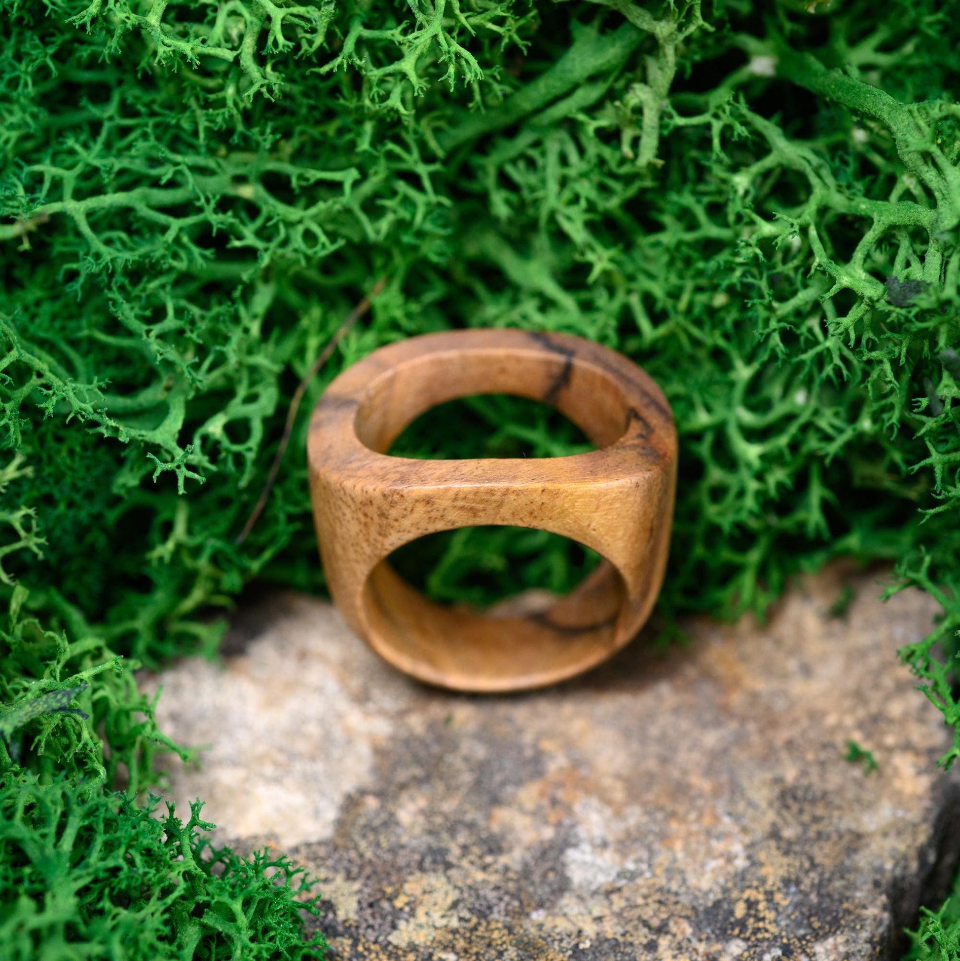 Close-up of a promise ring made from natural wood, a perfect gift for husband.