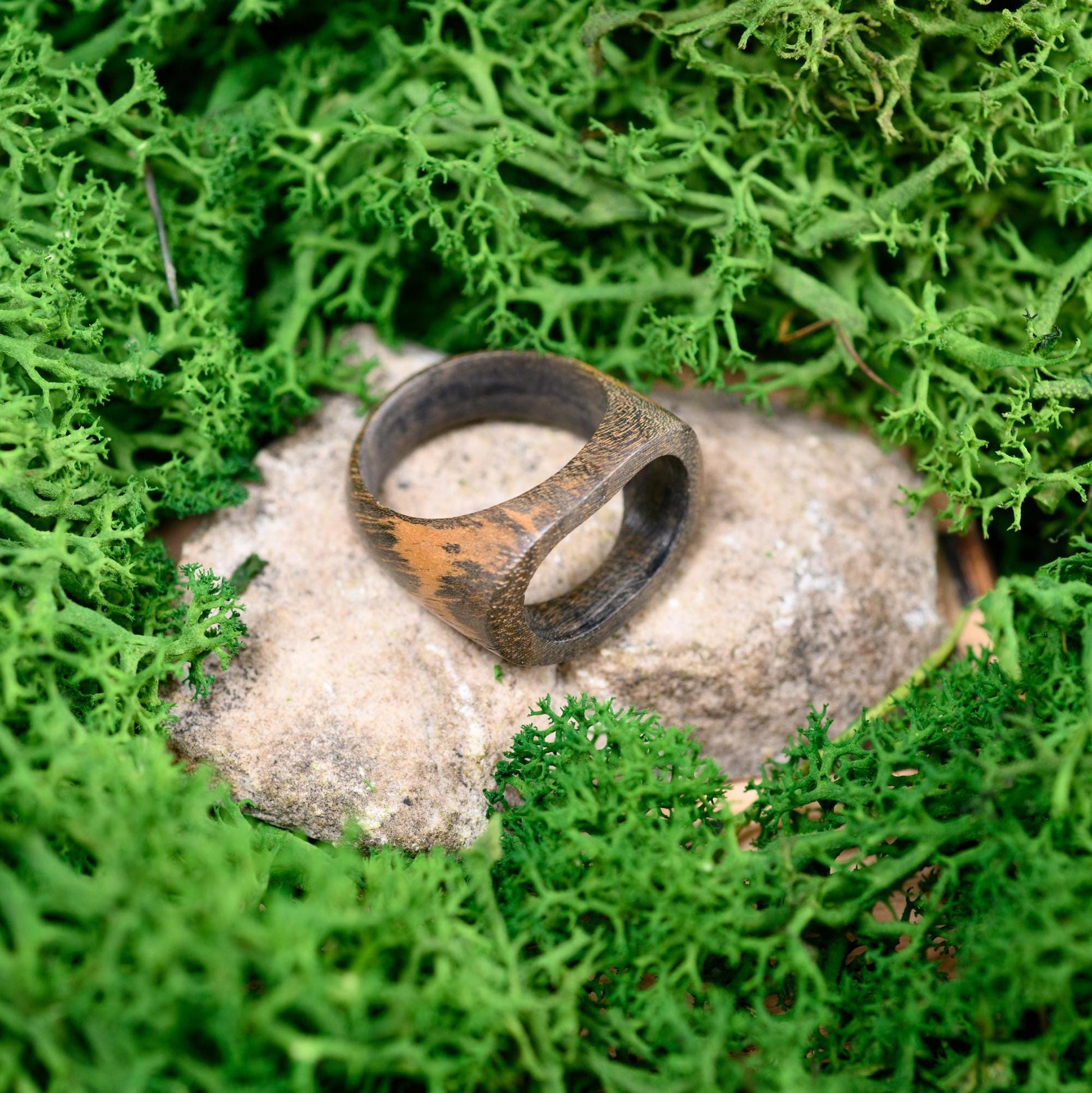 Minimalist men's wood ring with a sleek, organic look, perfect as an anniversary ring.