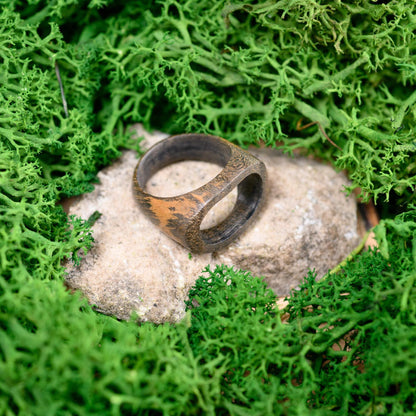 Minimalist men's wood ring with a sleek, organic look, perfect as an anniversary ring.