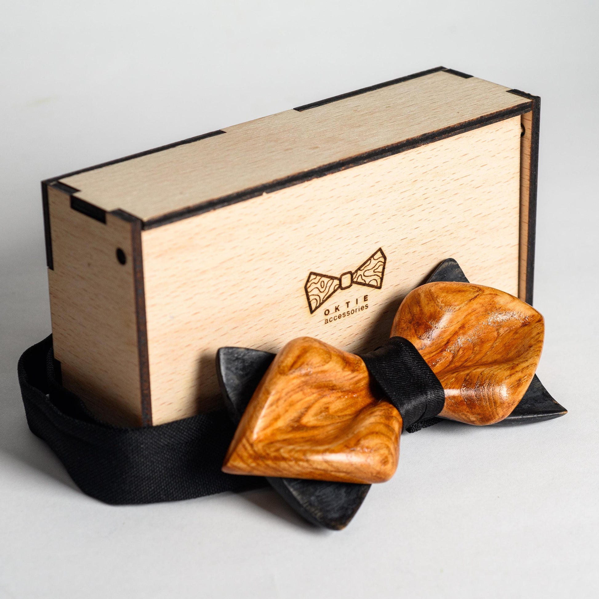 Close-up of personalized gift engraving on the center of the wooden bow tie