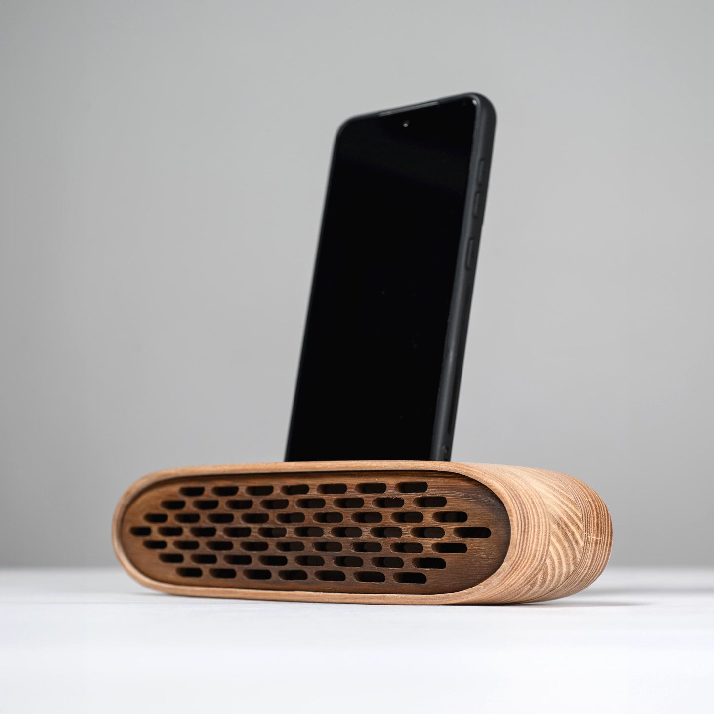 Handmade wooden phone speaker with an elliptical design – stylish docking station