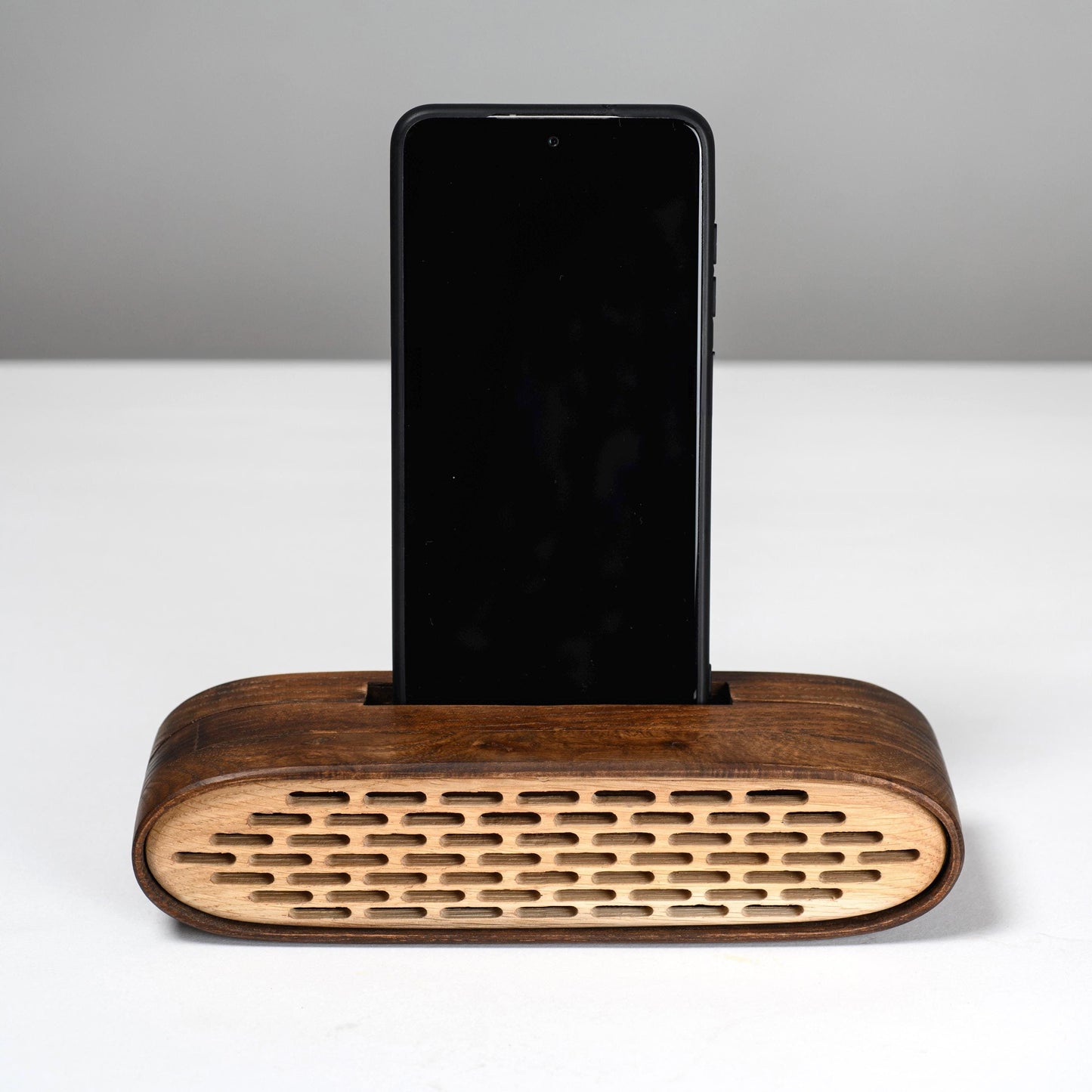 Handmade wooden phone speaker with an elliptical design – stylish docking station